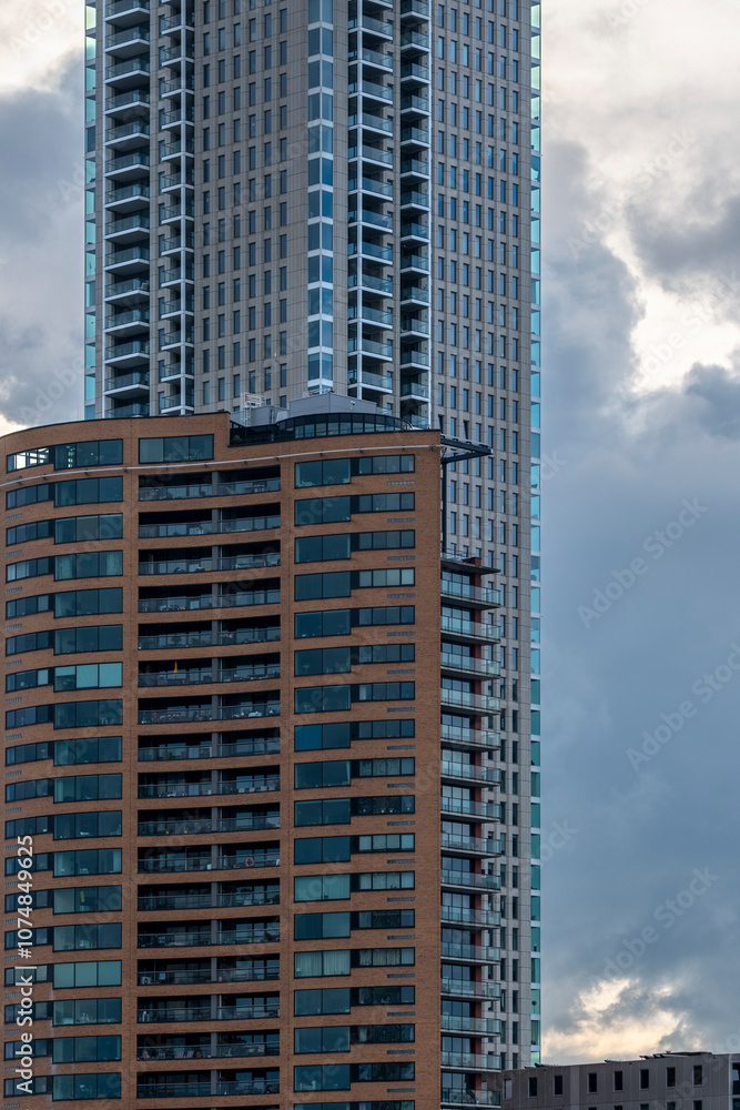 A high-rise urban tower dominates the surrounding cityscape, exemplifying modern architectural trends and the dense built environment of a vibrant city in Rotterdam A high-rise urban tower dominates the surrounding cityscape, exemplifying modern architectural trends and the dense built environment of a vibrant city in Rotterdam