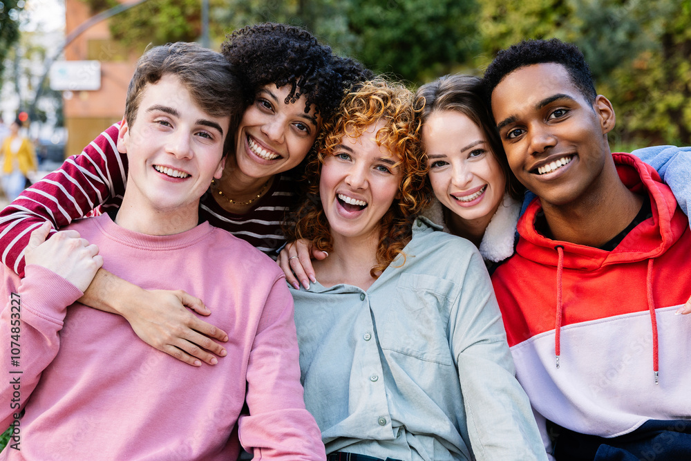 Portrait group of happy young gen z friends smiling at camera outdoor. Millennial diverse people relaxing together over urban background. Friendship and youth lifestyle concept. Portrait group of happy young gen z friends smiling at camera outdoor. Millennial diverse people relaxing together over urban background. Friendship and youth lifestyle concept.