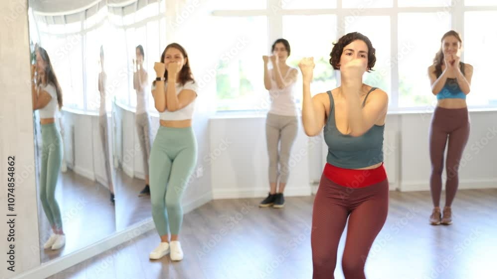 Smiling women learning swing steps at dance class. High quality 4k footage Smiling women learning swing steps at dance class. High quality 4k footage