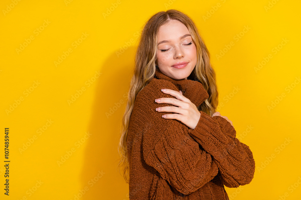 Profile photo of lovely young girl cuddle shoulder closed eyes empty space wear pullover isolated on yellow color background Profile photo of lovely young girl cuddle shoulder closed eyes empty space wear pullover isolated on yellow color background
