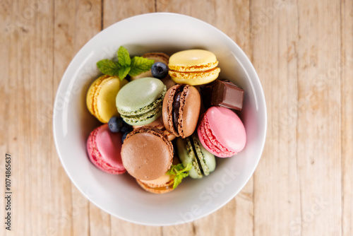 colorful macaroons in bowl, top view