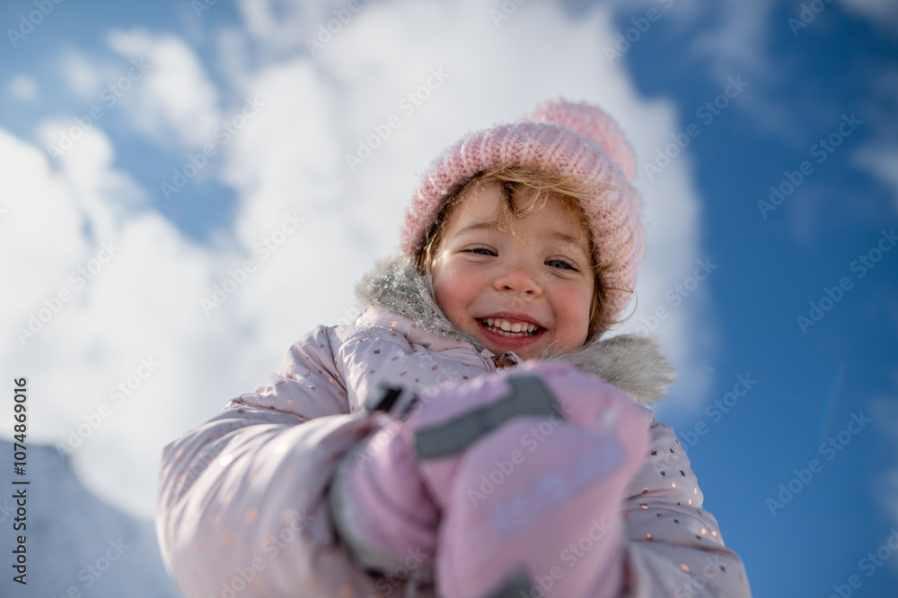 Portrait of small girl enjoying winter holiday in the mountains with family, playing in snow. Portrait of small girl enjoying winter holiday in the mountains with family, playing in snow.