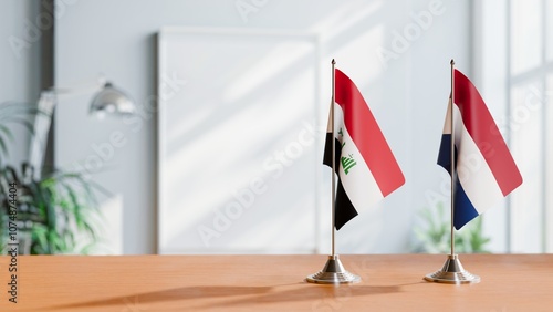 FLAGS OF IRAQ AND NETHERLANDS ON TABLE photo