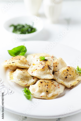 Dumplings with potato and cottage cheese stuffing (pierogi). Traditional Polish Christmas Dinner. Bright background.