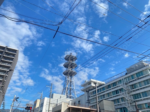 Rural Cityscape with Radio Tower and Mountain View on Sunny Day