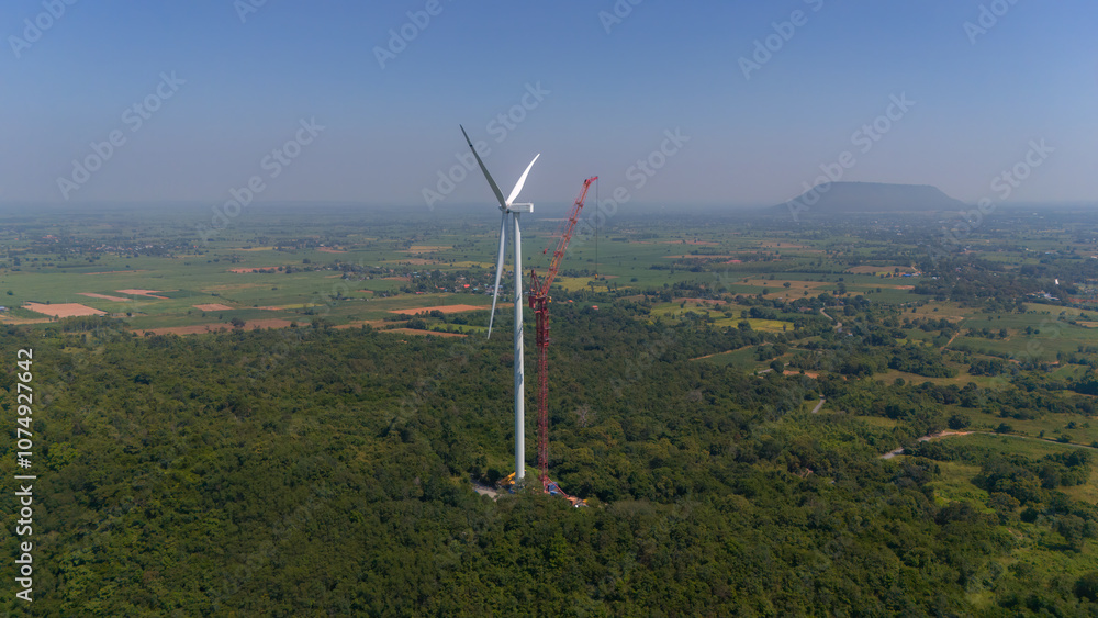 Wind turbine being repaired. Engineers are checking turbine wing on top of a Hight Crane at Wind turbine Power. Crane taking down the blades of an old wind turbine Wind turbine being repaired. Engineers are checking turbine wing on top of a Hight Crane at Wind turbine Power. Crane taking down the blades of an old wind turbine