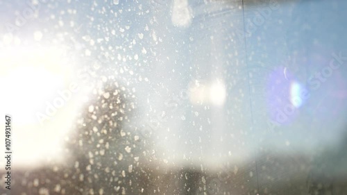 Rays of sunlight passing through a dirty window pane on a clear summer day