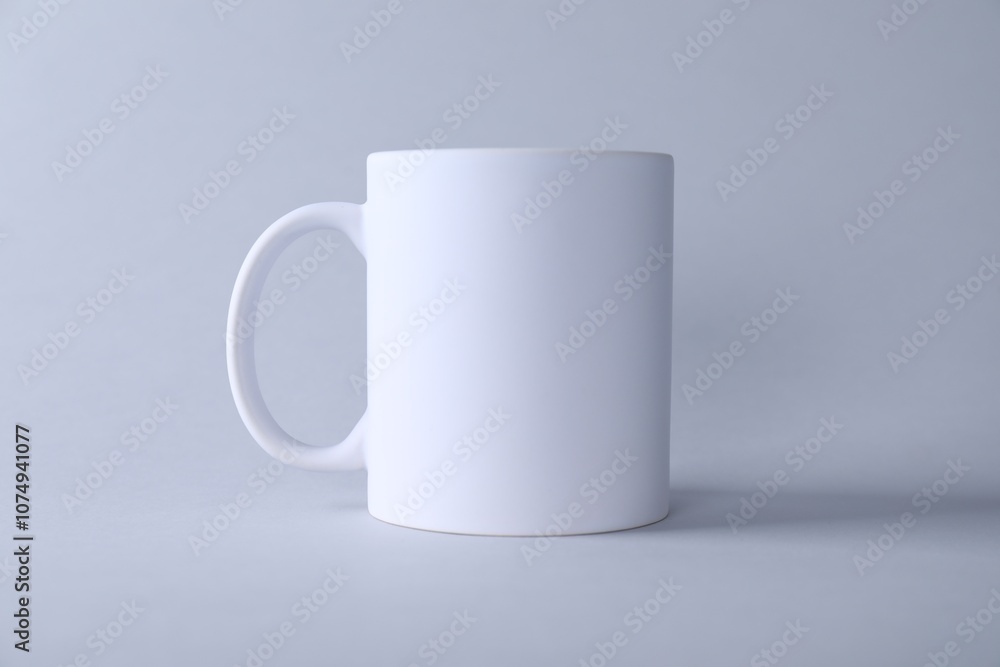 One blank white mug on light background. Mockup for design One blank white mug on light background. Mockup for design