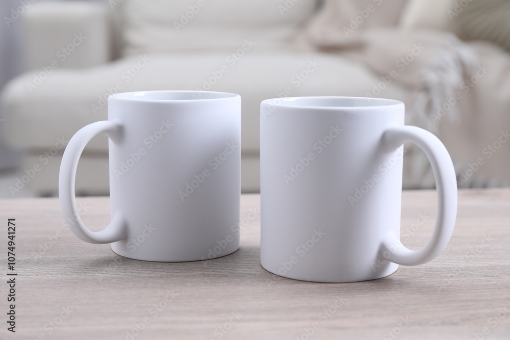 Blank ceramic mugs on white wooden table. Mockup for design Blank ceramic mugs on white wooden table. Mockup for design