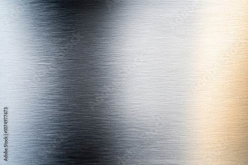 Close-up of a sleek, brushed metal surface exhibiting a gradient of silver shades with subtle reflections, ideal for modern design projects. photo