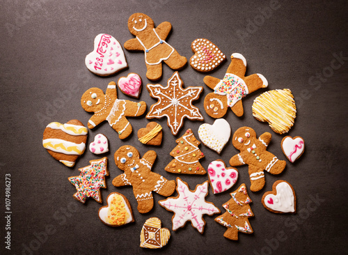 many christmas gingerbread cookies on dark background.