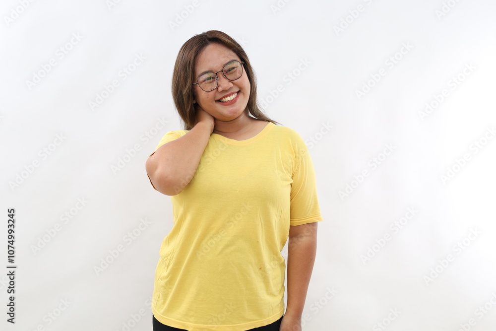 Confident Asian woman has cheerful expression standing against white background Confident Asian woman has cheerful expression standing against white background