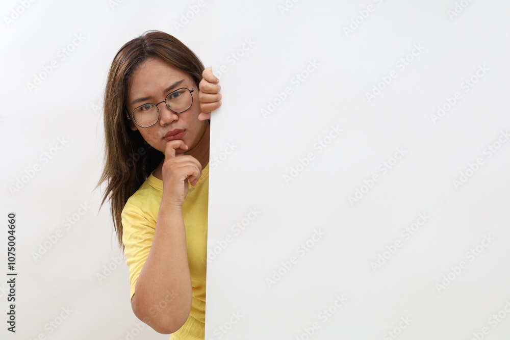 Young Asian woman is standing behind the white blank banner or empty copy space advertisement board on white background, Looking at camera Young Asian woman is standing behind the white blank banner or empty copy space advertisement board on white background, Looking at camera