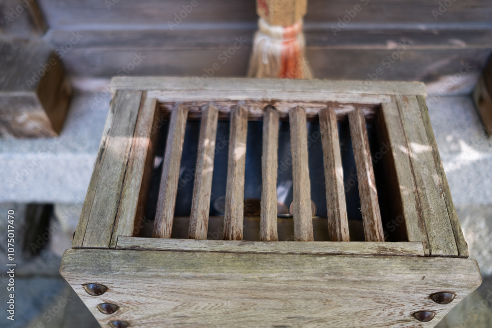 Japanese traditional donation coin box in the temple