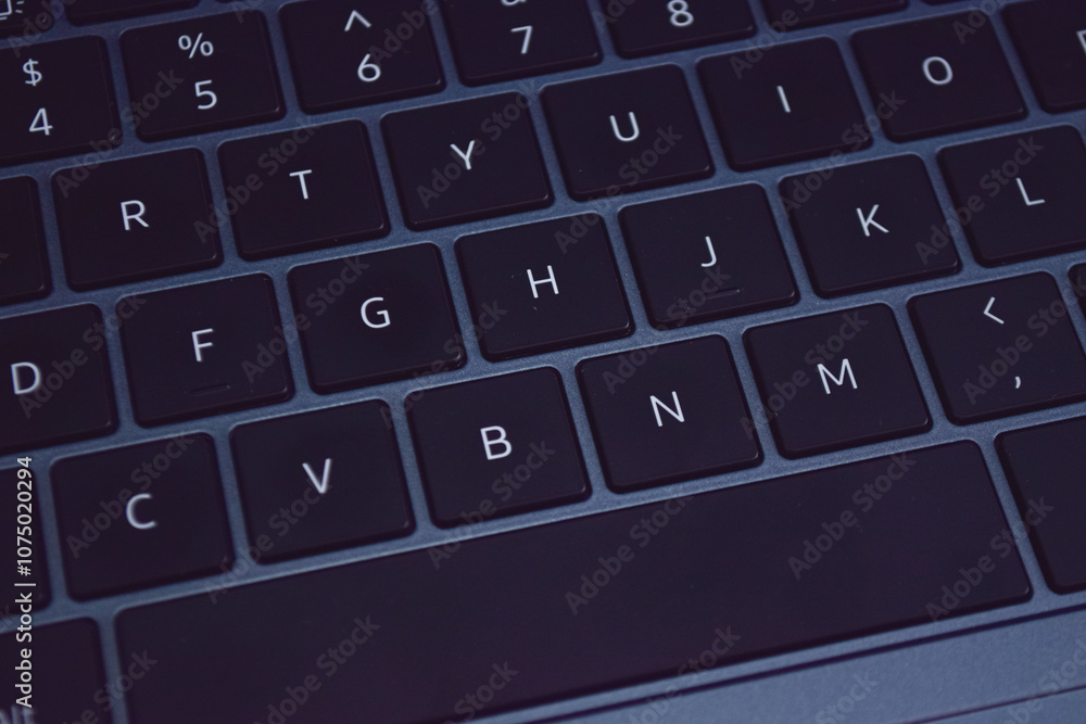 Close-up view of a laptop keyboard, showcasing the precise arrangement of keys. Close-up view of a laptop keyboard, showcasing the precise arrangement of keys.