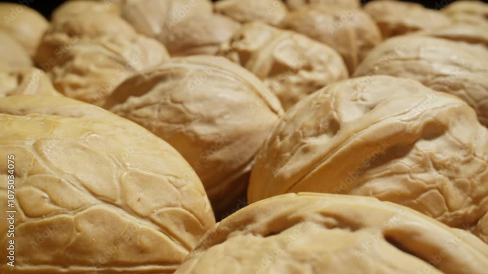 Walnuts. Pile of nuts. Healthy vegan food concept. Healthy nutrition. Unpeeled walnut background. Dolly slider shot. Zoom in. Close-up in 4K, UHD Walnuts. Pile of nuts. Healthy vegan food concept. Healthy nutrition. Unpeeled walnut background. Dolly slider shot. Zoom in. Close-up in 4K, UHD