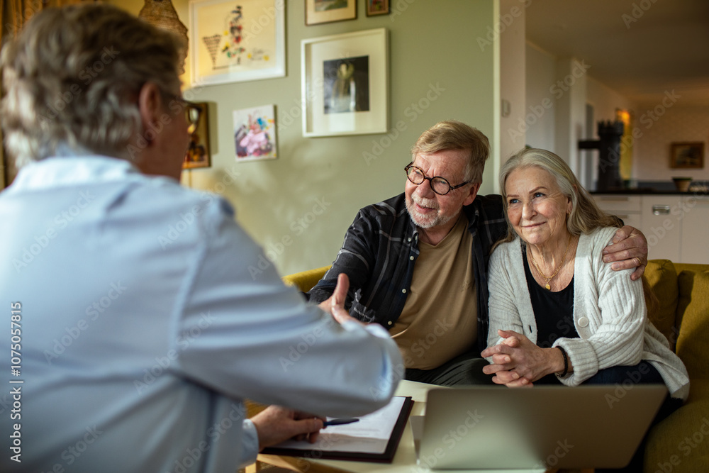 Senior couple talking to financial advisor at home Senior couple talking to financial advisor at home