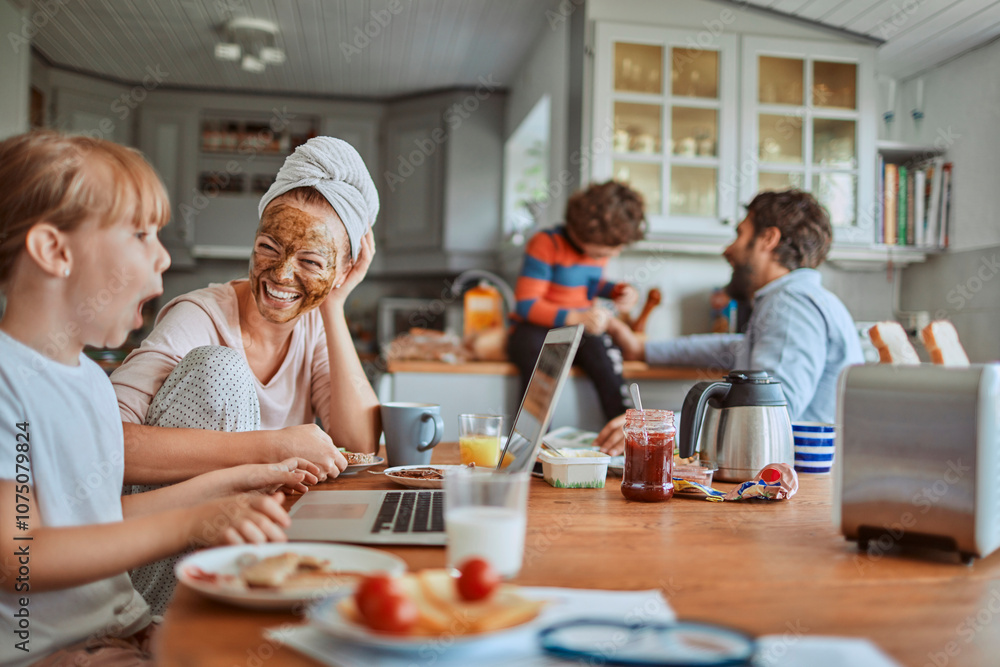 Happy family enjoying breakfast together in kitchen Happy family enjoying breakfast together in kitchen