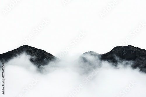 Misty mountain peaks shrouded in clouds create a serene natural landscape.