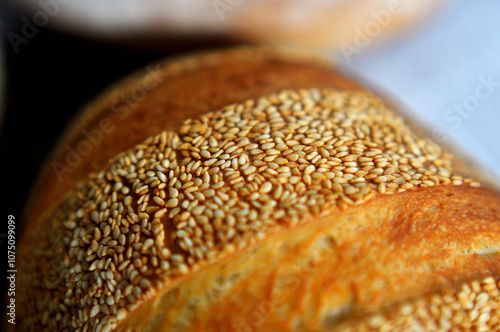 Photo of crust with sesame seeds of home baked bread