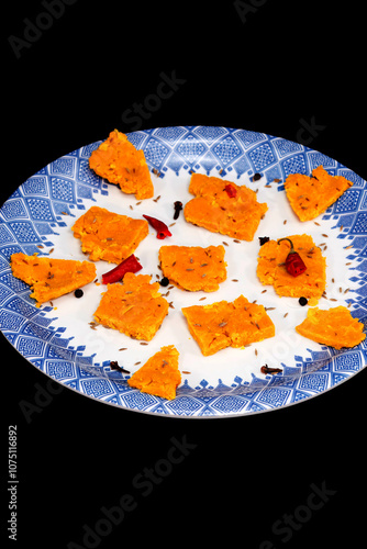 Gujarati Kathiyawadi Spicy Dhokali Pieces Sabji highlights the dish, alone against a dark backdrop photo