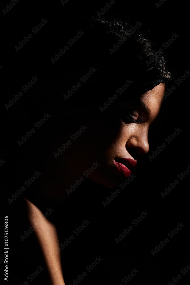 A confident young woman stands elegantly in a studio, showcasing her red lips. A confident young woman stands elegantly in a studio, showcasing her red lips.