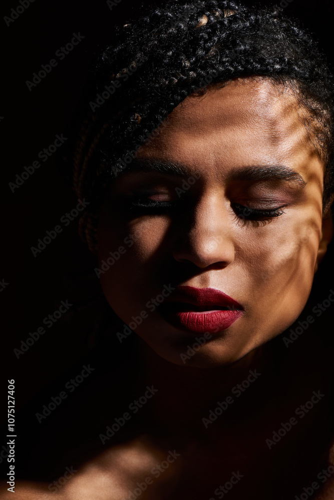 A young, fashionable woman with braided hair poses gracefully, showcasing her striking red lips in a studio setting. A young, fashionable woman with braided hair poses gracefully, showcasing her striking red lips in a studio setting.