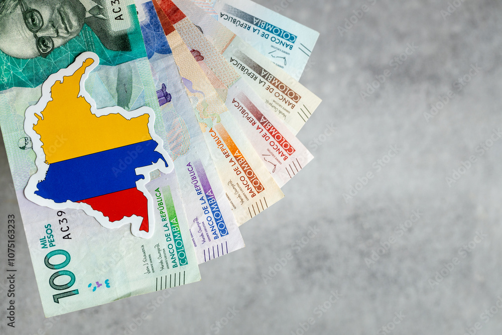 Colombia money and national emblem, Gray background, copy space, flat lay, Financial background, Colombian pesos