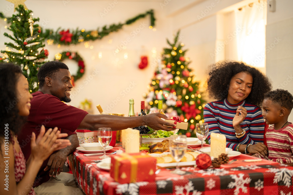 A cheerful holiday dinner scene with a diverse family enjoying a festive meal. Christmas decorations, gifts, and a lit Christmas tree create a cozy atmosphere, enhancing the warmth of the celebration. A cheerful holiday dinner scene with a diverse family enjoying a festive meal. Christmas decorations, gifts, and a lit Christmas tree create a cozy atmosphere, enhancing the warmth of the celebration.