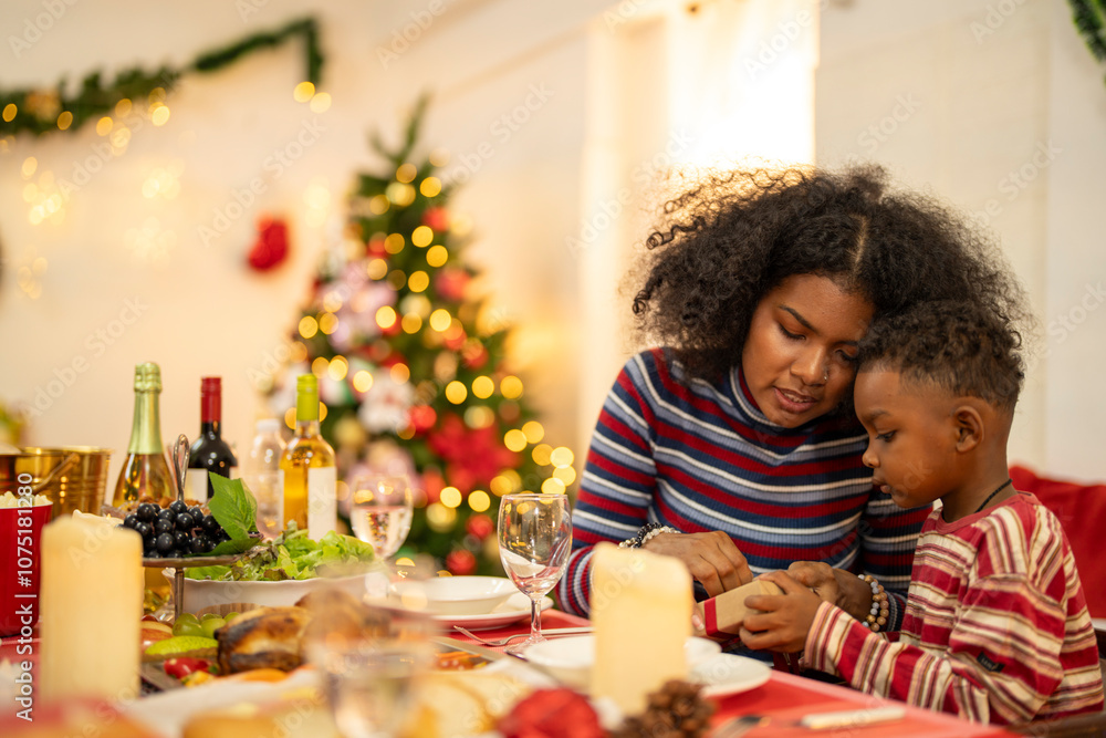 A cheerful holiday dinner scene with a diverse family enjoying a festive meal. Christmas decorations, gifts, and a lit Christmas tree create a cozy atmosphere, enhancing the warmth of the celebration. A cheerful holiday dinner scene with a diverse family enjoying a festive meal. Christmas decorations, gifts, and a lit Christmas tree create a cozy atmosphere, enhancing the warmth of the celebration.