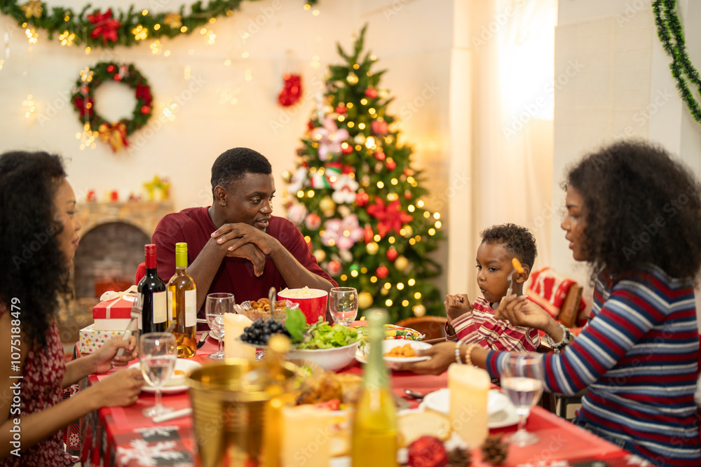 A warm Christmas family dinner with a father serving food to his young child, surrounded by festive decorations, a Christmas tree, and a holiday table spread. Joyful and cozy holiday atmosphere. A warm Christmas family dinner with a father serving food to his young child, surrounded by festive decorations, a Christmas tree, and a holiday table spread. Joyful and cozy holiday atmosphere.