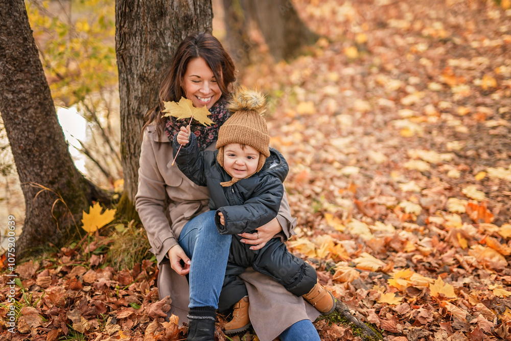 Joyful mother and his little baby. mother and child have fun, laugh and enjoy nature outdoors at autumn park. Joyful mother and his little baby. mother and child have fun, laugh and enjoy nature outdoors at autumn park.