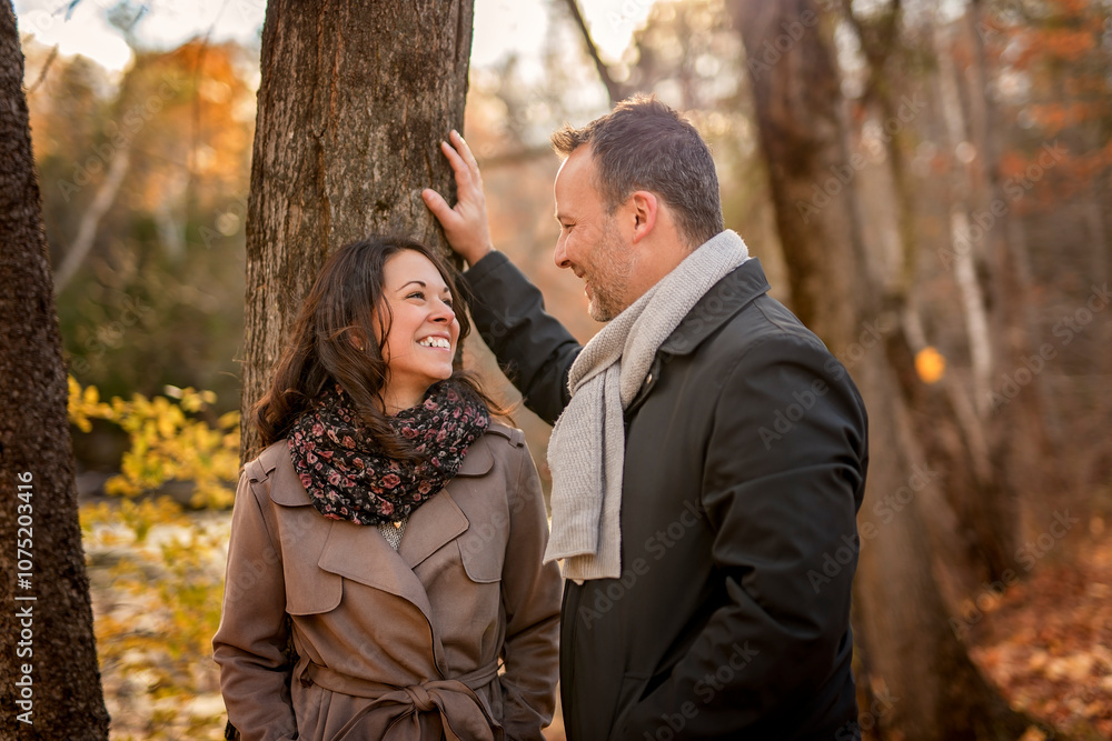 Couple Embracing on Park Bench. lovely couple kissing outdoors in autumn Couple Embracing on Park Bench. lovely couple kissing outdoors in autumn