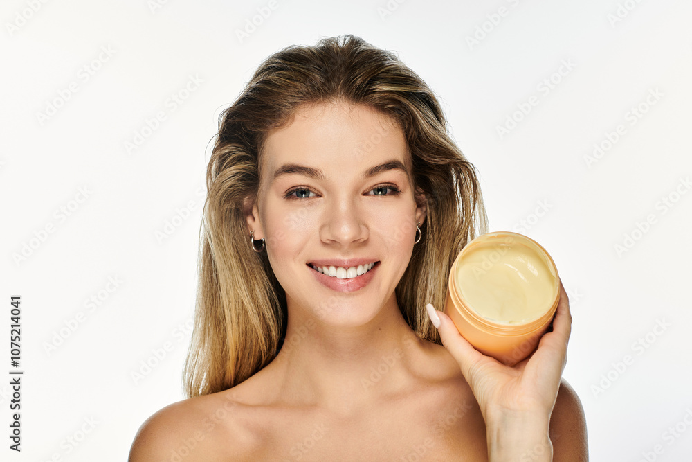 A young woman beams with joy while showcasing a jar of skin cream against a luminous background. A young woman beams with joy while showcasing a jar of skin cream against a luminous background.