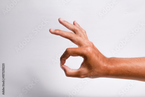 Male hand showing ok sign on isolated white background