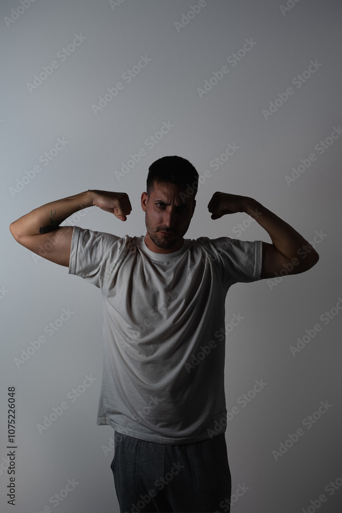 Portrait of man flexing biceps Portrait of man flexing biceps
