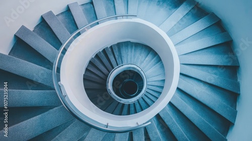 Abstract view of a spiral staircase, close-up of railings and steps emphasizing smooth lines.