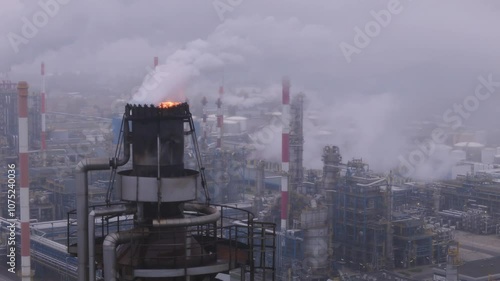  Industrial Refinery Emitting Smoke into Foggy Atmosphere