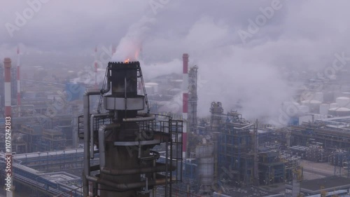  Industrial Refinery Emitting Smoke into Foggy Atmosphere