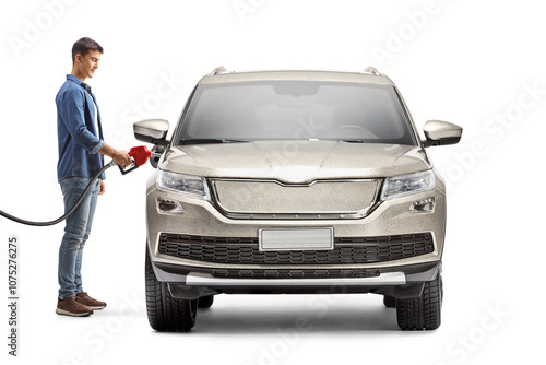 Young man filling a car with petrol photo