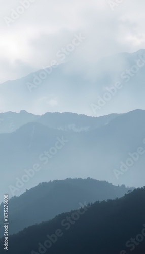 Misty Mountain Landscape at Dawn Showcasing Layered Hills and Soft Light in Serene Atmosphere