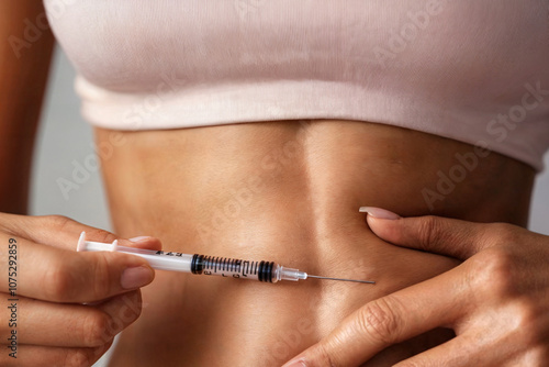 woman taking a semaglutide injection in her stomach. diabetes. weight management