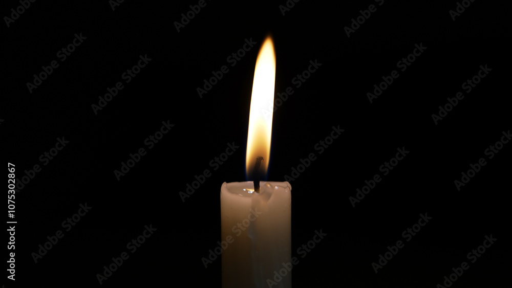 A single candle burns brightly in the dark, symbolizing sorrow and remembrance. This moment captures the essence of a heartfelt religious ceremony honoring loss and grief. A single candle burns brightly in the dark, symbolizing sorrow and remembrance. This moment captures the essence of a heartfelt religious ceremony honoring loss and grief.