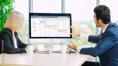 Project planning software for modish business project management on the computer screen showing timeline chart of the team project photo