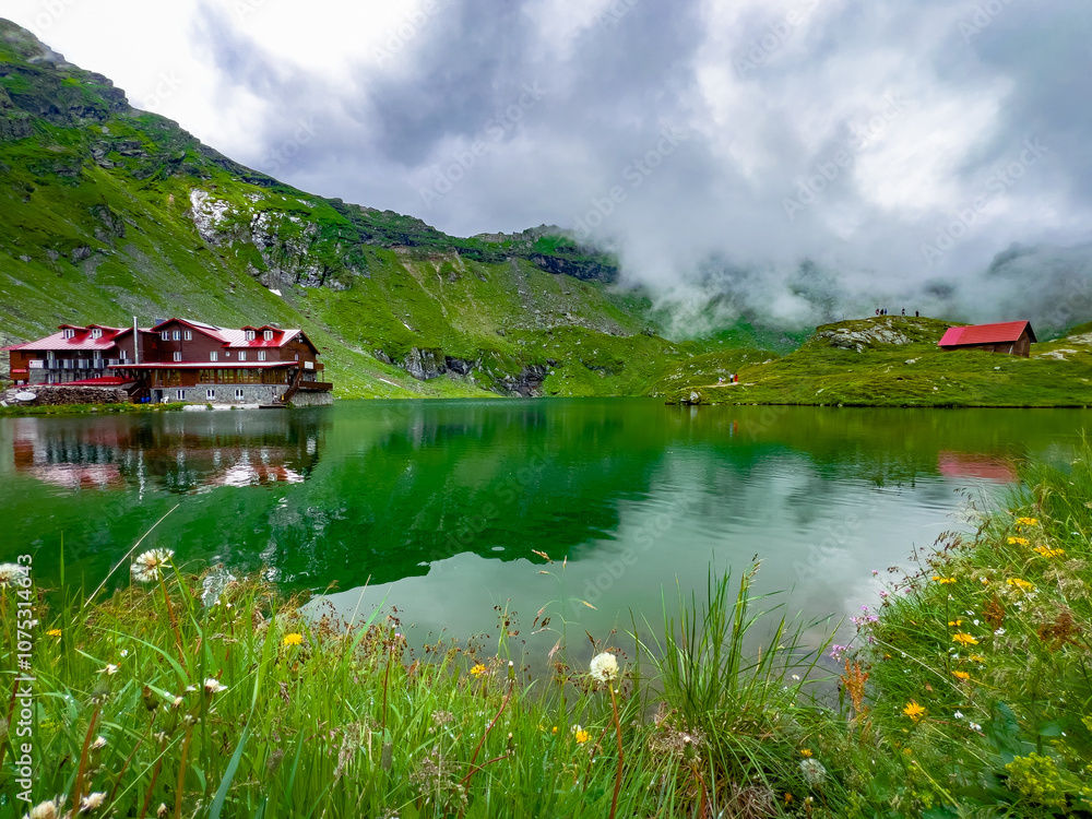 Fototapeta premium Aerial view of lake Balea and Transfagarasan road in the Fagaras Mountains, Romania