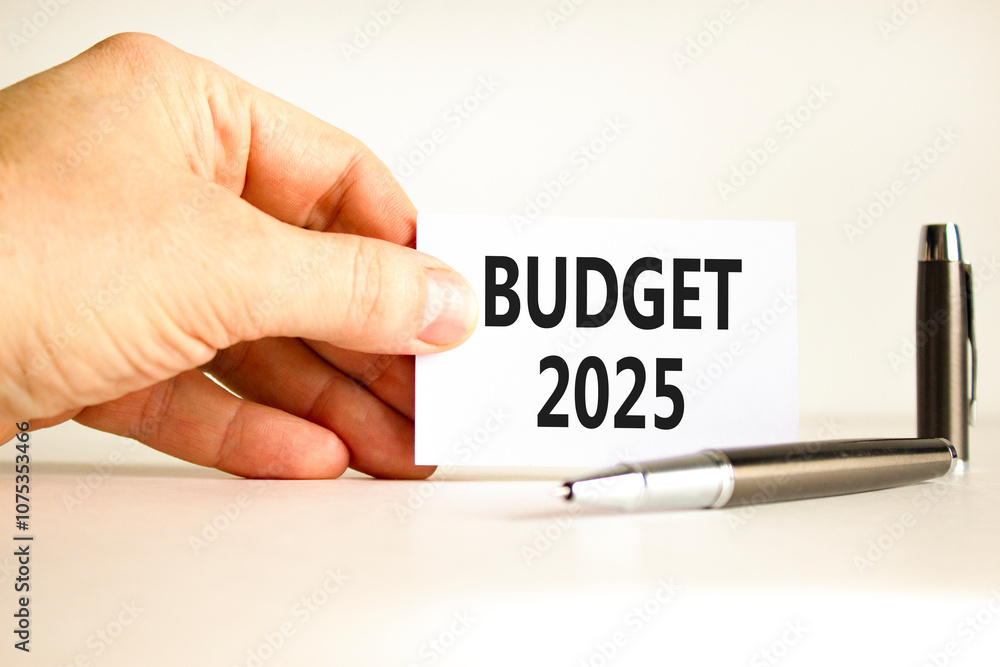 Planning budget 2025 new year symbol. Concept words Budget 2025 on beautiful white card. Beautiful white background. Businessman hand. Business budget 2025 new year concept. Copy space. Planning budget 2025 new year symbol. Concept words Budget 2025 on beautiful white card. Beautiful white background. Businessman hand. Business budget 2025 new year concept. Copy space.