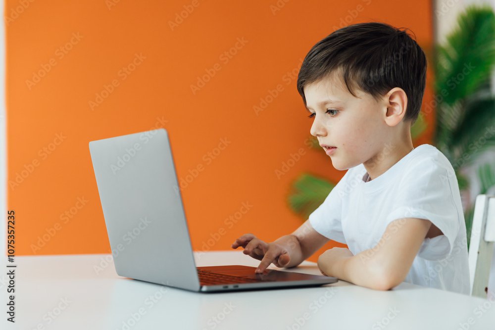 Boy Learning Online With A Laptop At A Table At Home Boy Learning Online With A Laptop At A Table At Home