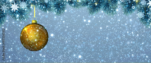 Christmas ball hanging on fir tree branch isolated on gray.