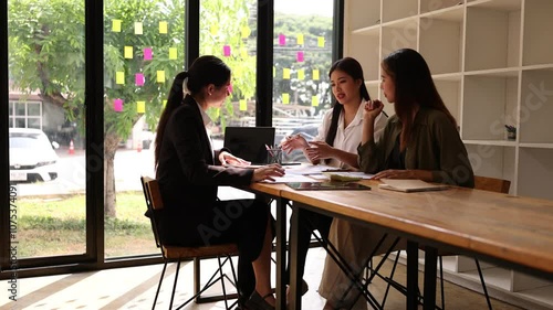 Asian businesswoman teamwork working together on table with analysis report and advisor showing plan, Business marketing and finance at meeting room of the workplace concept.