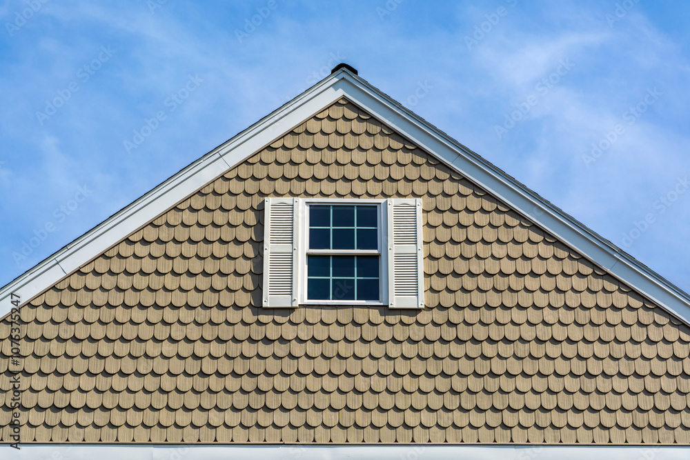 House gable end with scalloped shingle siding in Brighton, Massachusetts, USA House gable end with scalloped shingle siding in Brighton, Massachusetts, USA